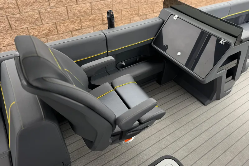 Slide: The Image of Interior of 2025 Manitou EXPLORE 24 boat with modern seating and dashboard. - 22