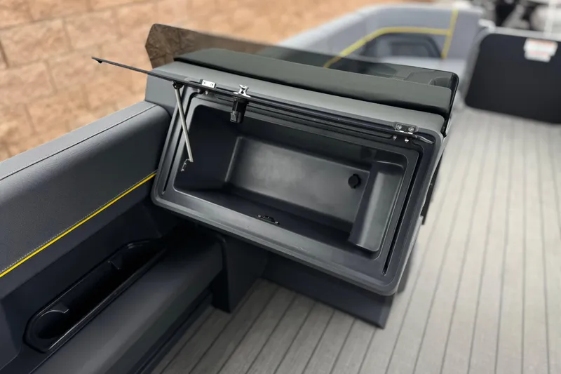 Slide: The Image of Open storage compartment on 2025 Manitou EXPLORE 24 boat, featuring sleek interior design. - 23