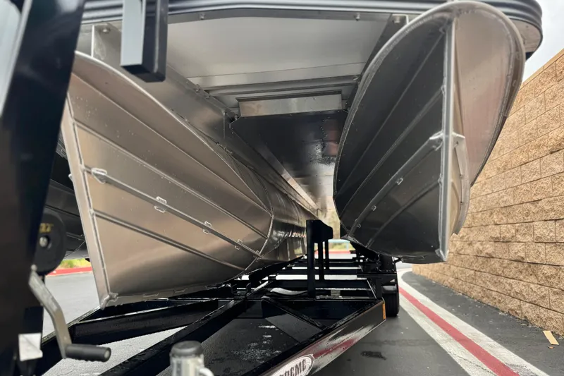 Slide: The Image of Underneath view of a 2025 Manitou EXPLORE 24 pontoon boat on a trailer. - 4
