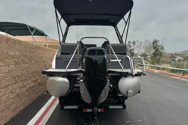 Slide: The Image of 2025 Manitou EXPLORE 24 pontoon boat rear view on a trailer. - 5