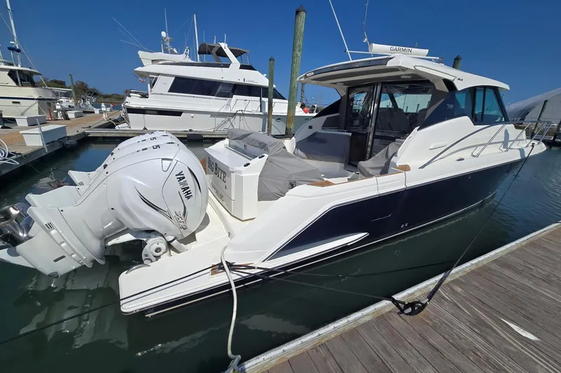 Slide: The Image of 2022 Tiara Yachts 43 LE docked, featuring Yamaha outboard engines. - 10
