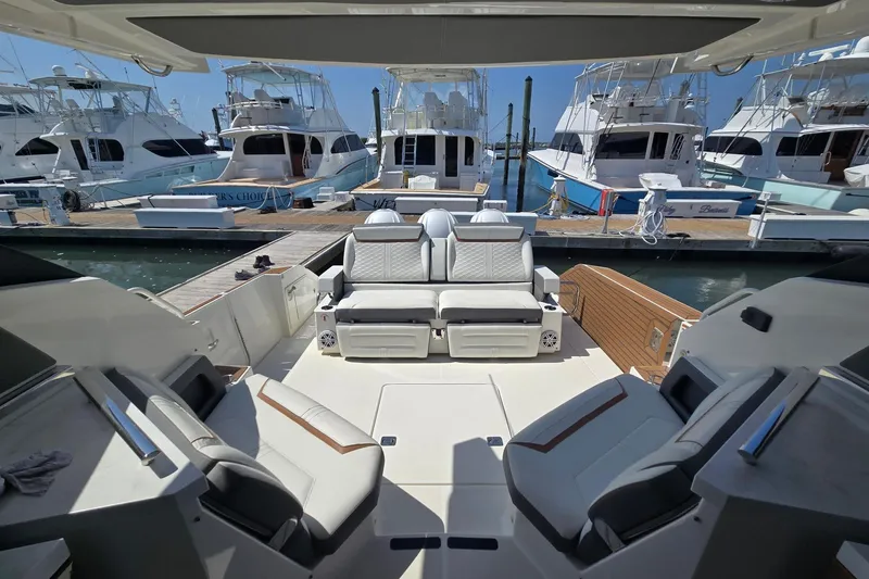 Slide: The Image of 2022 Tiara Yachts 43 LE interior with luxurious seating at marina. - 12