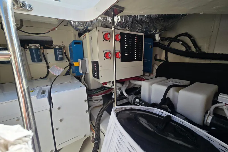 Slide: The Image of Engine room of 2022 Tiara Yachts 43 LE, showcasing electrical systems and components. - 13