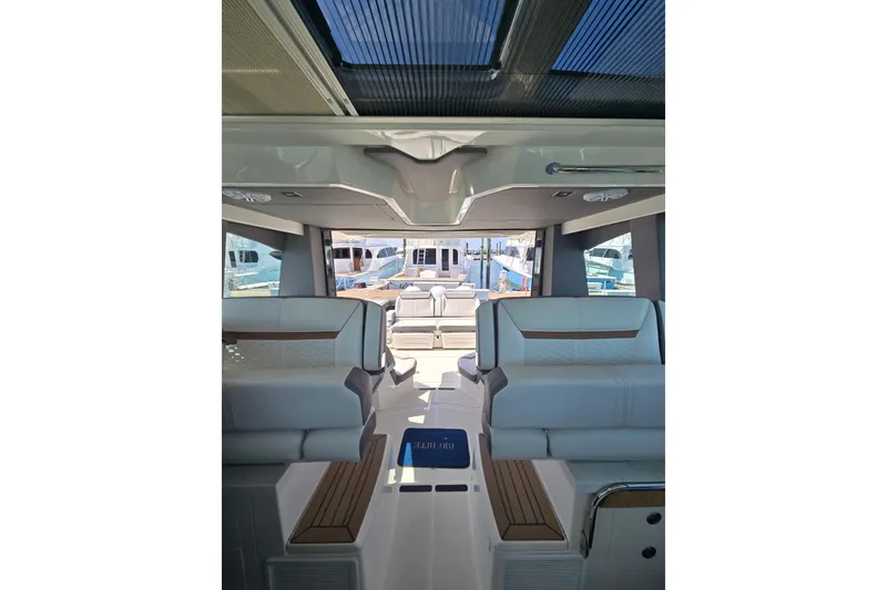 Slide: The Image of Interior view of 2022 Tiara Yachts 43 LE, showcasing luxurious seating and sleek design. - 14