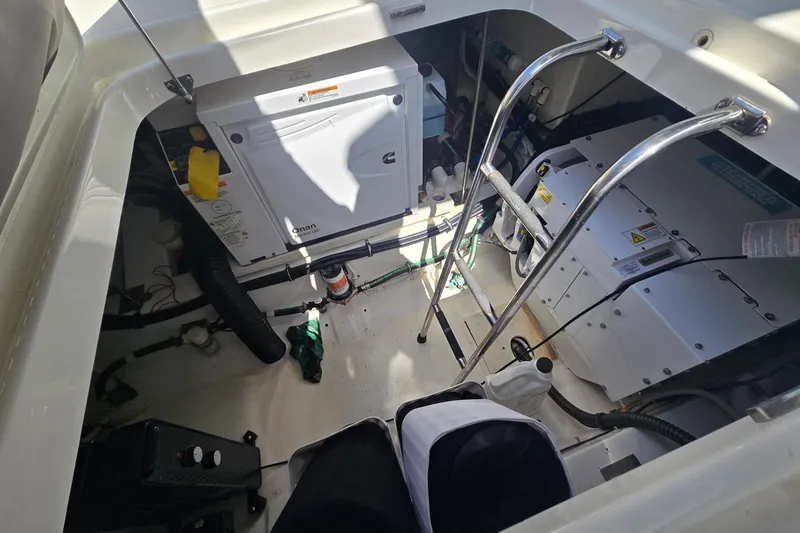 Slide: The Image of Engine compartment of 2022 Tiara Yachts 43 LE, featuring Onan generator and equipment. - 15