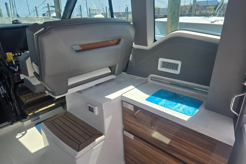 Slide: The Image of Interior of 2022 Tiara Yachts 43 LE, featuring sleek seating and modern cabinetry. - 18