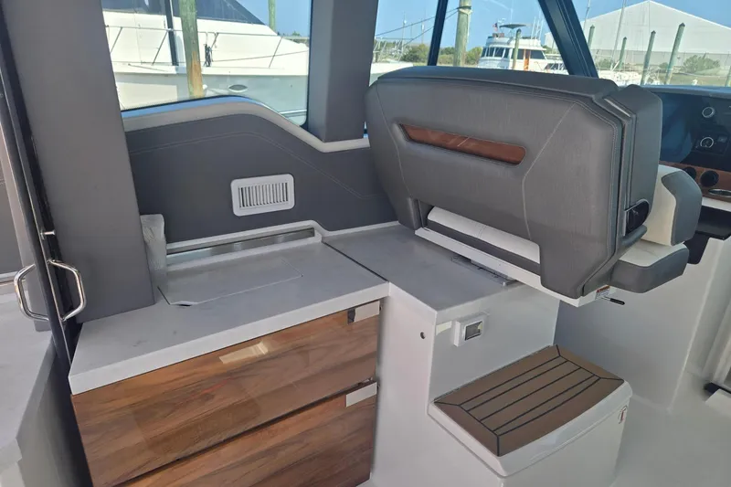 Slide: The Image of 2022 Tiara Yachts 43 LE interior with sleek seating and modern cabinetry. - 19