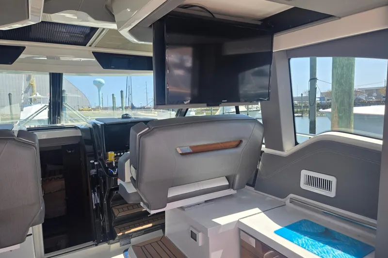 Slide: The Image of Interior of 2022 Tiara Yachts 43 LE with modern seating and mounted TV. - 20