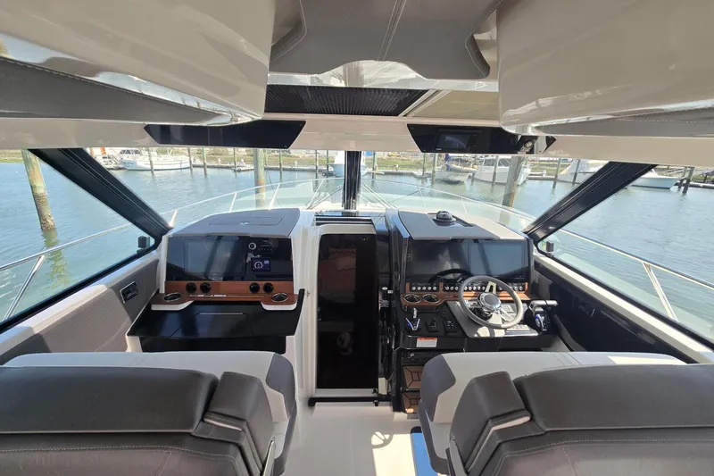 Slide: The Image of Interior view of 2022 Tiara Yachts 43 LE helm with modern controls and dual seating. - 21