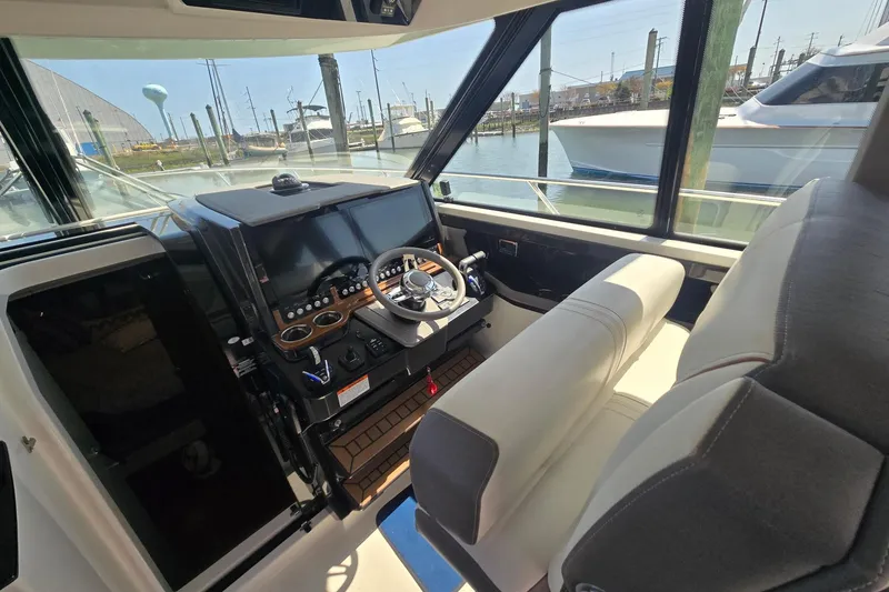 Slide: The Image of 2022 Tiara Yachts 43 LE helm with modern controls and comfortable seating. - 22