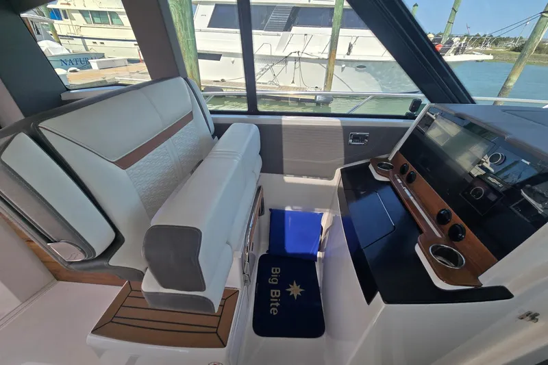 Slide: The Image of 2022 Tiara Yachts 43 LE interior with helm station and seating. - 23