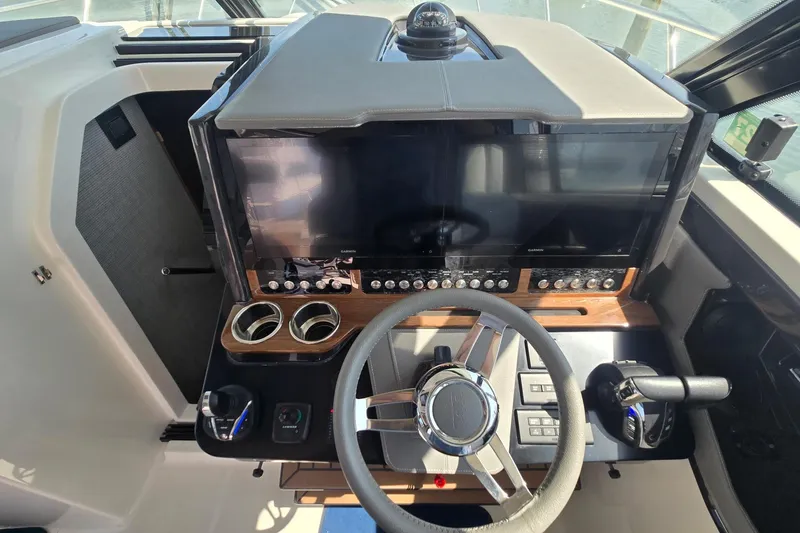Slide: The Image of Helm of 2022 Tiara Yachts 43 LE with modern controls and navigation displays. - 25