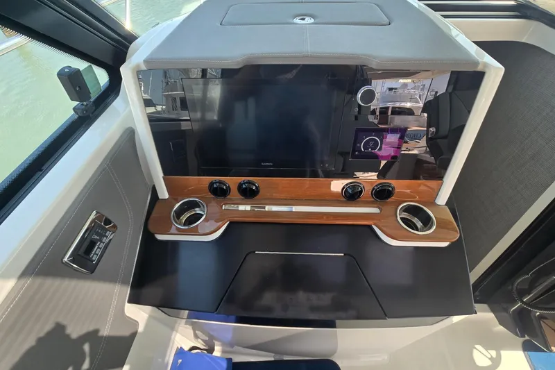 Slide: The Image of 2022 Tiara Yachts 43 LE dashboard with modern controls and sleek design. - 26