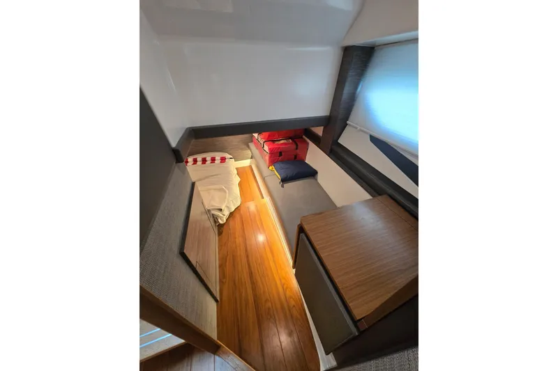 Slide: The Image of 2022 Tiara Yachts 43 LE cabin interior with wooden flooring and cozy bedding. - 28