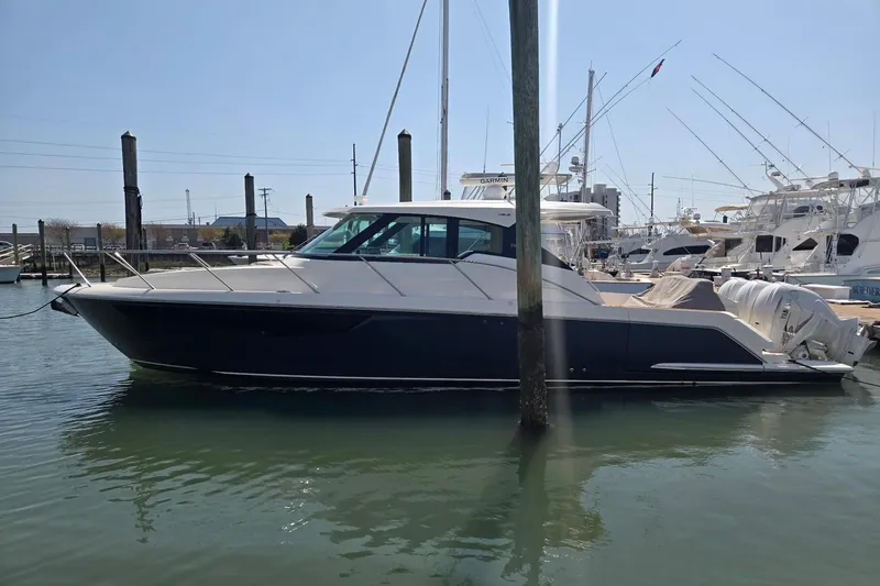 Slide: The Image of 2022 Tiara Yachts 43 LE docked in a marina, side view. - 3