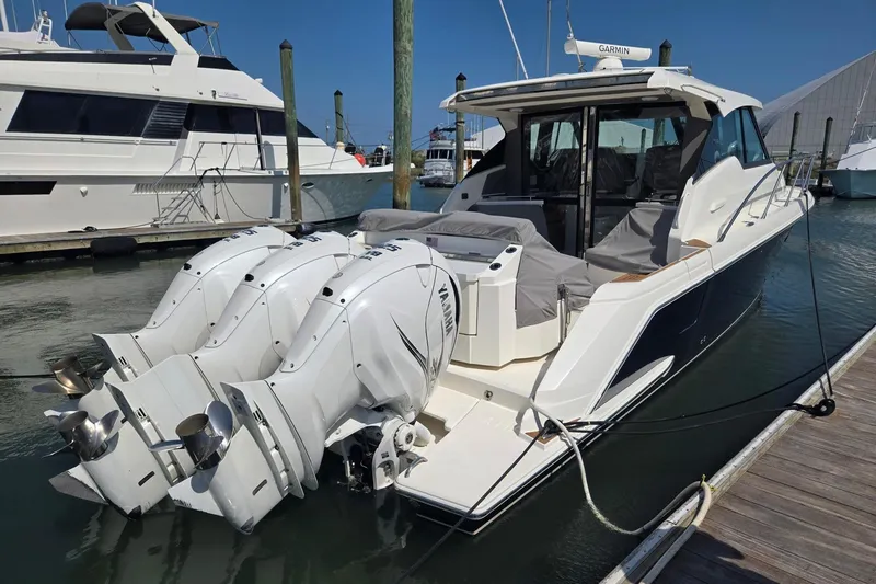 Slide: The Image of 2022 Tiara Yachts 43 LE with triple Yamaha engines docked at marina. - 5