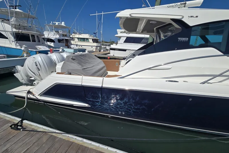 Slide: The Image of 2022 Tiara Yachts 43 LE docked, featuring sleek design and Yamaha outboard engines. - 7