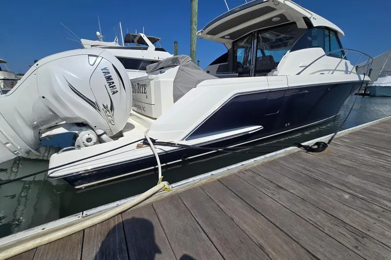 Slide: The Image of 2022 Tiara Yachts 43 LE docked, featuring Yamaha outboard engines. - 9