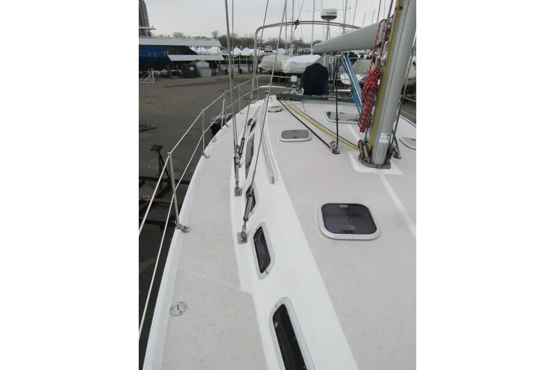 Slide: The Image of Deck view of a 1999 Catalina 380 sailboat, showcasing hatches and rigging. - 11