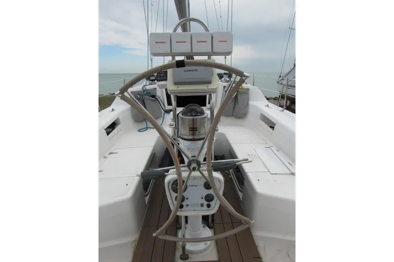 Slide: The Image of Cockpit of a 1999 Catalina 380 sailboat with steering wheel and navigation equipment. - 14