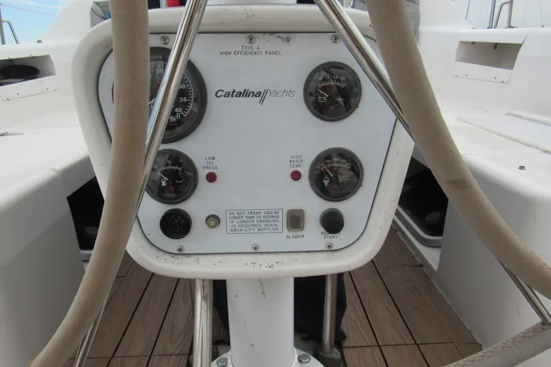 Slide: The Image of Control panel of a 1999 Catalina 380 yacht with gauges and switches. - 15