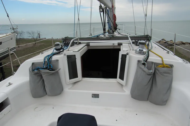 Slide: The Image of Sailboat cockpit of 1999 Catalina 380 with open hatch, docked by the sea. - 18