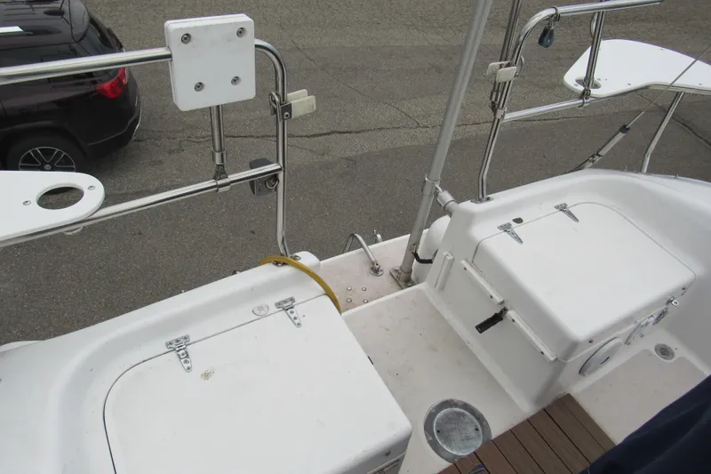 Slide: The Image of Deck view of a 1999 Catalina 380 sailboat, featuring storage compartments and railing. - 19