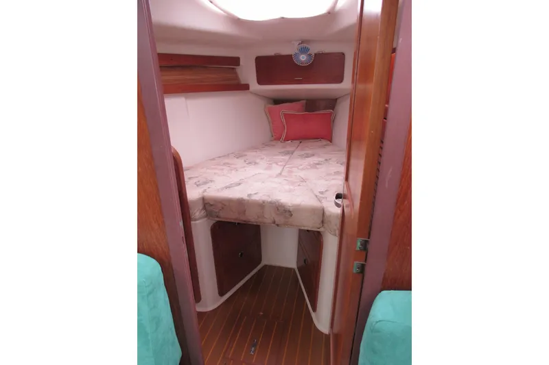 Slide: The Image of Cozy cabin interior of 1999 Catalina 380 sailboat with bed and wooden accents. - 26
