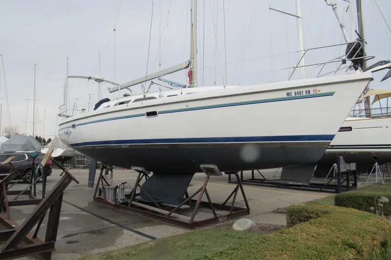 Slide: The Image of 1999 Catalina 380 sailboat on stands in a marina, ready for maintenance. - 3