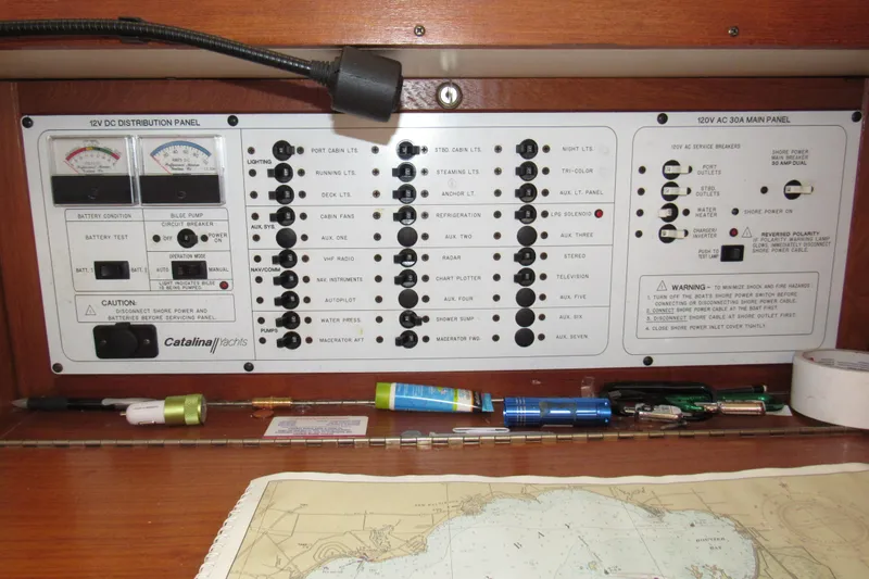 Slide: The Image of Electrical control panel of a 1999 Catalina 380 yacht with navigation chart. - 31