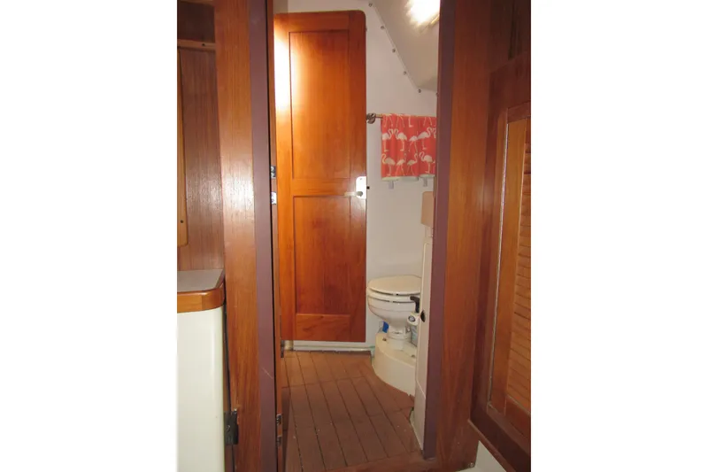 Slide: The Image of Interior of 1999 Catalina 380 yacht bathroom with wooden door and marine toilet. - 36