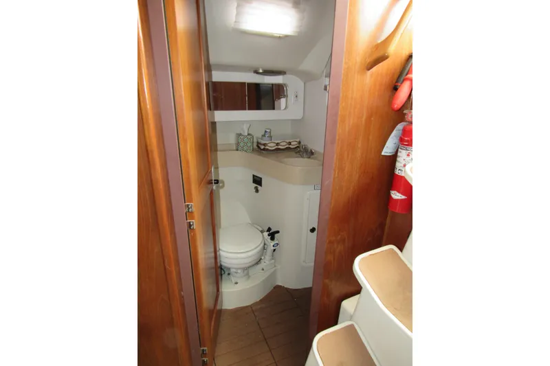 Slide: The Image of 1999 Catalina 380 yacht bathroom interior with wooden finish and compact design. - 37