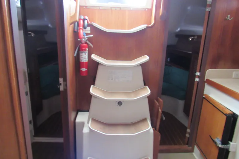 Slide: The Image of Interior of 1999 Catalina 380 sailboat with wooden cabinetry and fire extinguisher. - 38
