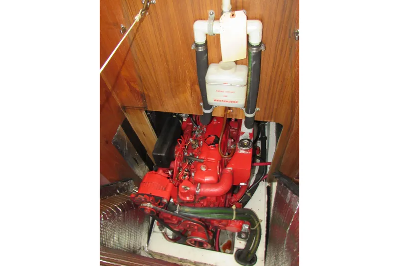 Slide: The Image of Engine compartment of a 1999 Catalina 380 sailboat, featuring a red Westerbeke engine. - 39