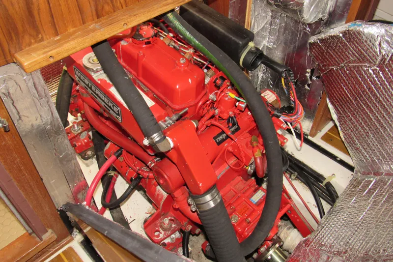 Slide: The Image of Engine compartment of a 1999 Catalina 380 sailboat with red engine components. - 40