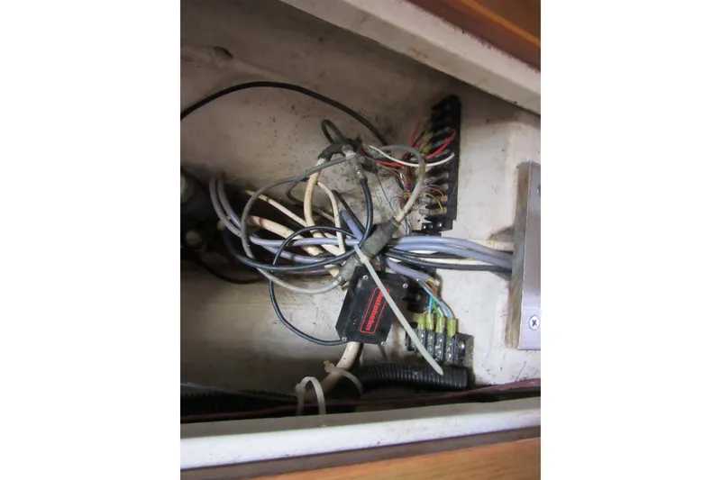 Slide: The Image of Electrical wiring inside a 1999 Catalina 380 boat, showcasing cables and connectors. - 42