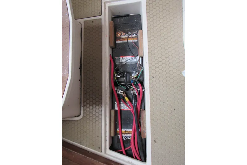 Slide: The Image of Battery compartment of a 1999 Catalina 380 sailboat with visible wiring. - 44