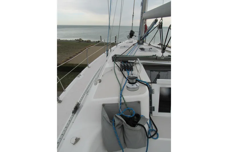 Slide: The Image of Deck view of a 1999 Catalina 380 sailboat with ocean in the background. - 8