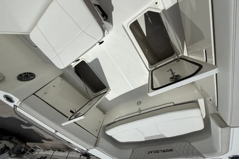Slide: The Image of Interior view of 2026 World Cat 235 TE boat, featuring seating and storage compartments. - 11