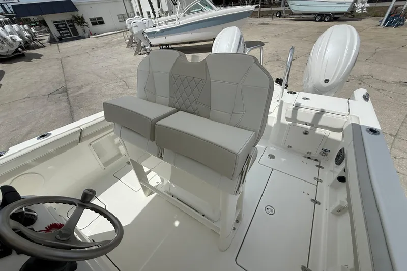 Slide: The Image of 2026 World Cat 235 TE boat interior with dual seats and steering wheel. - 13