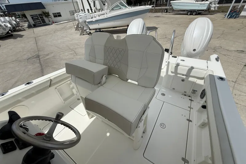 Slide: The Image of 2026 World Cat 235 TE boat interior with steering wheel and cushioned seating. - 14