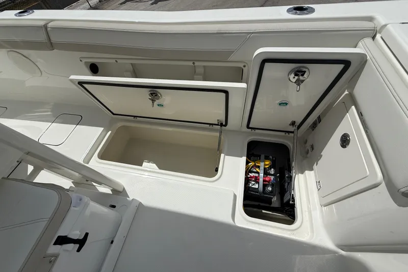 Slide: The Image of 2026 World Cat 235 TE boat storage compartments and battery area. - 15