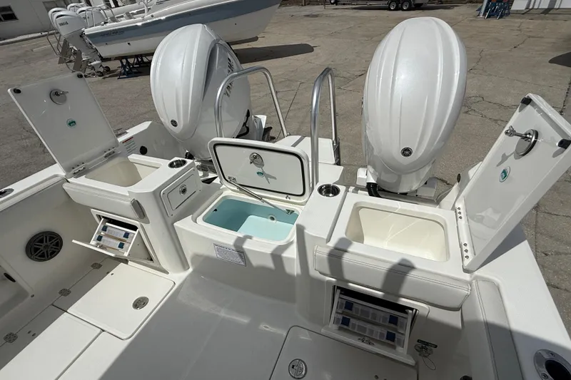 Slide: The Image of 2026 World Cat 235 TE boat with dual engines and open storage compartments. - 16
