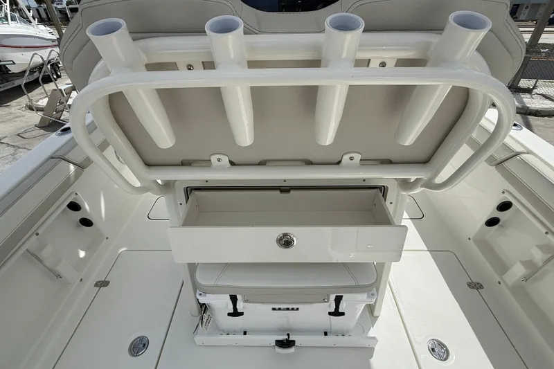 Slide: The Image of 2026 World Cat 235 TE boat interior with rod holders and storage drawer. - 17