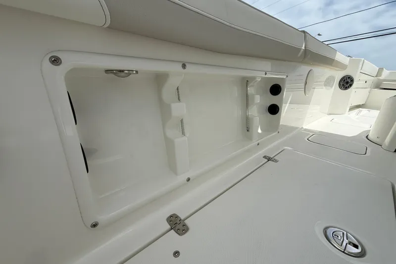 Slide: The Image of 2026 World Cat 235 TE boat interior storage compartment with sleek white finish. - 19