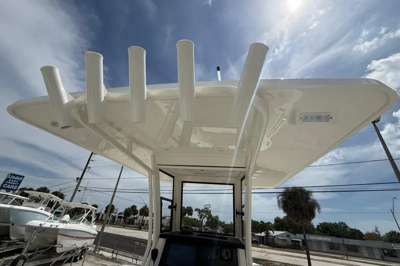Slide: The Image of 2026 World Cat 235 TE boat with rod holders under a clear blue sky. - 20