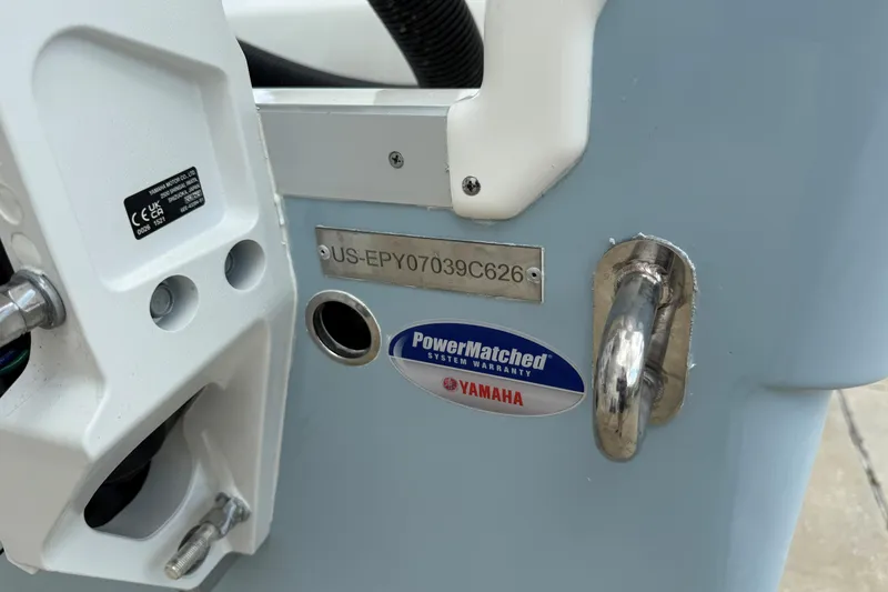 Slide: The Image of 2026 World Cat 235 TE boat detail with Yamaha PowerMatched warranty sticker. - 21