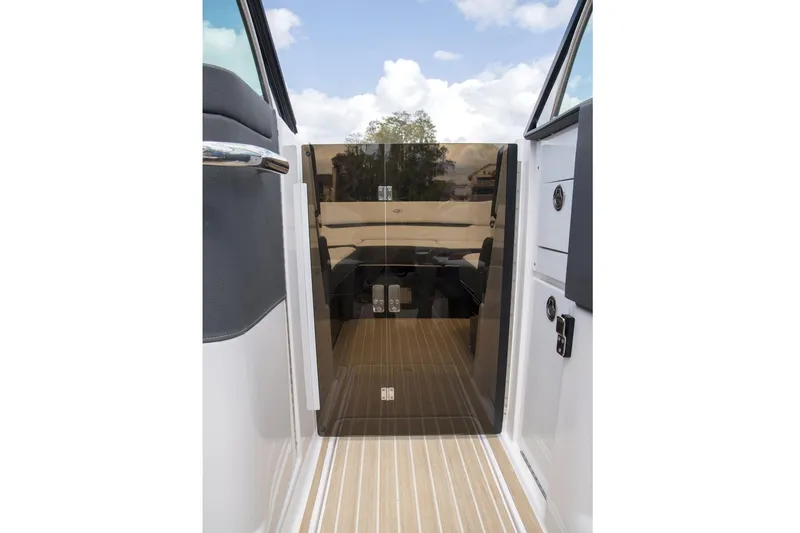 Slide: The Image of Manufacturer Provided Image: 2017 Regal 2800 Bowrider boat interior with closed cabin door. - 9