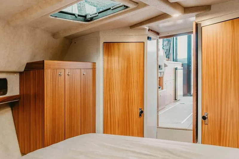 Slide: The Image of Luxurious interior of 2026 KingFisher 38 GFX yacht with wooden cabinetry and skylight. - 10