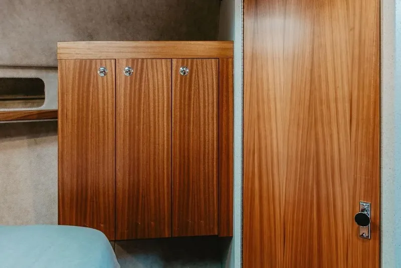 Slide: The Image of Interior of 2026 KingFisher 38 GFX boat with wooden cabinetry and door. - 11